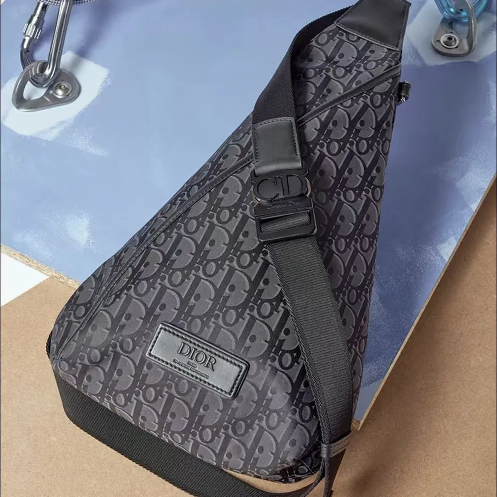 Close-up of zipped closure and silver hardware on Dior Men Trek Sling Bag