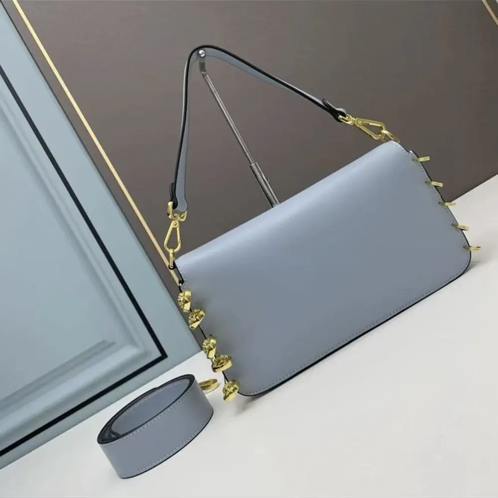 Close-up of signature brooch on Fendi Women Baguette Brooch Fendace Blue Leather Bag