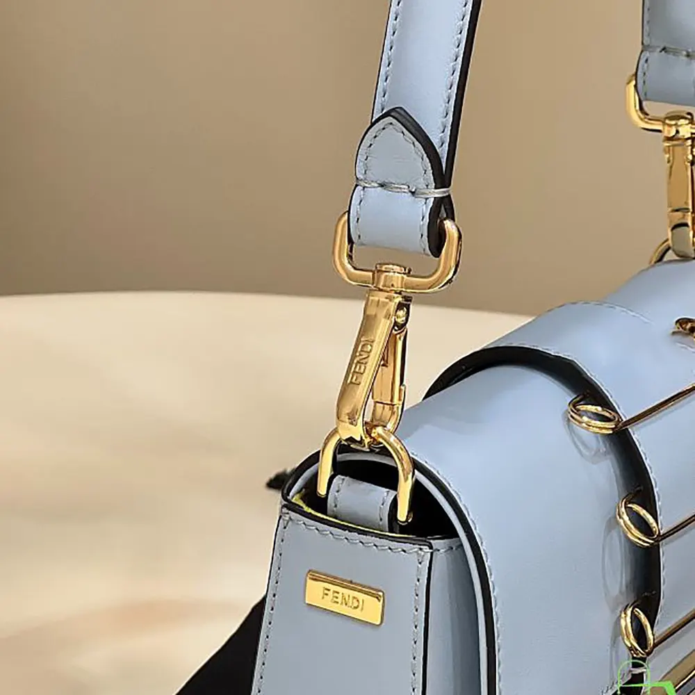 Side angle showing compact silhouette of Fendi Women Brooch Mini Baguette bag