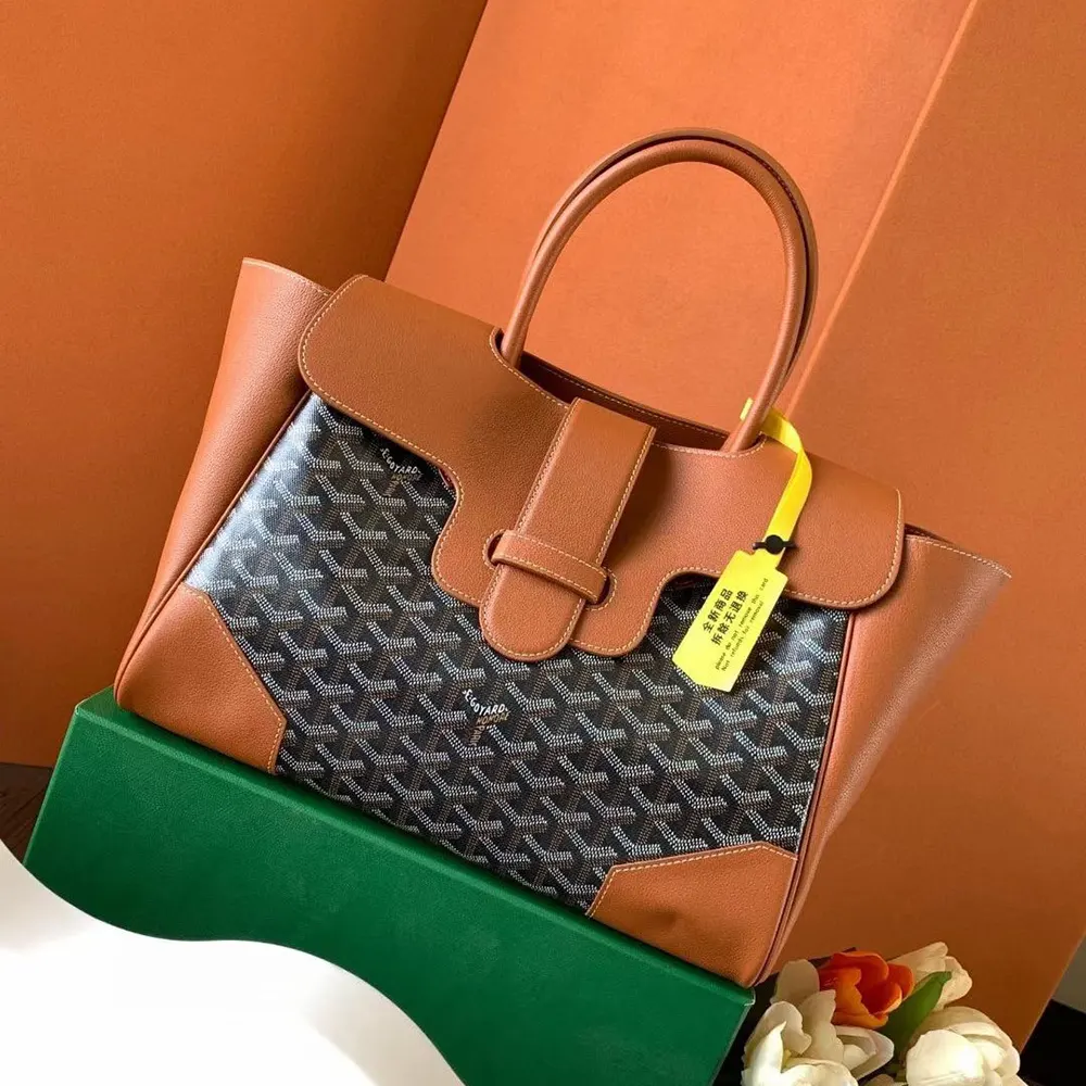 Close-up of brass hardware and leather trim on Goyard Saïgon Tote Bag-Brown