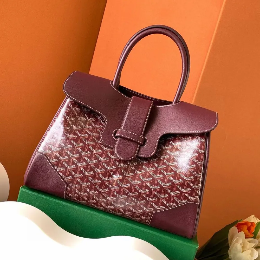 Close-up of leather trim and brass hardware on Saïgon Tote Bag-Burgundy