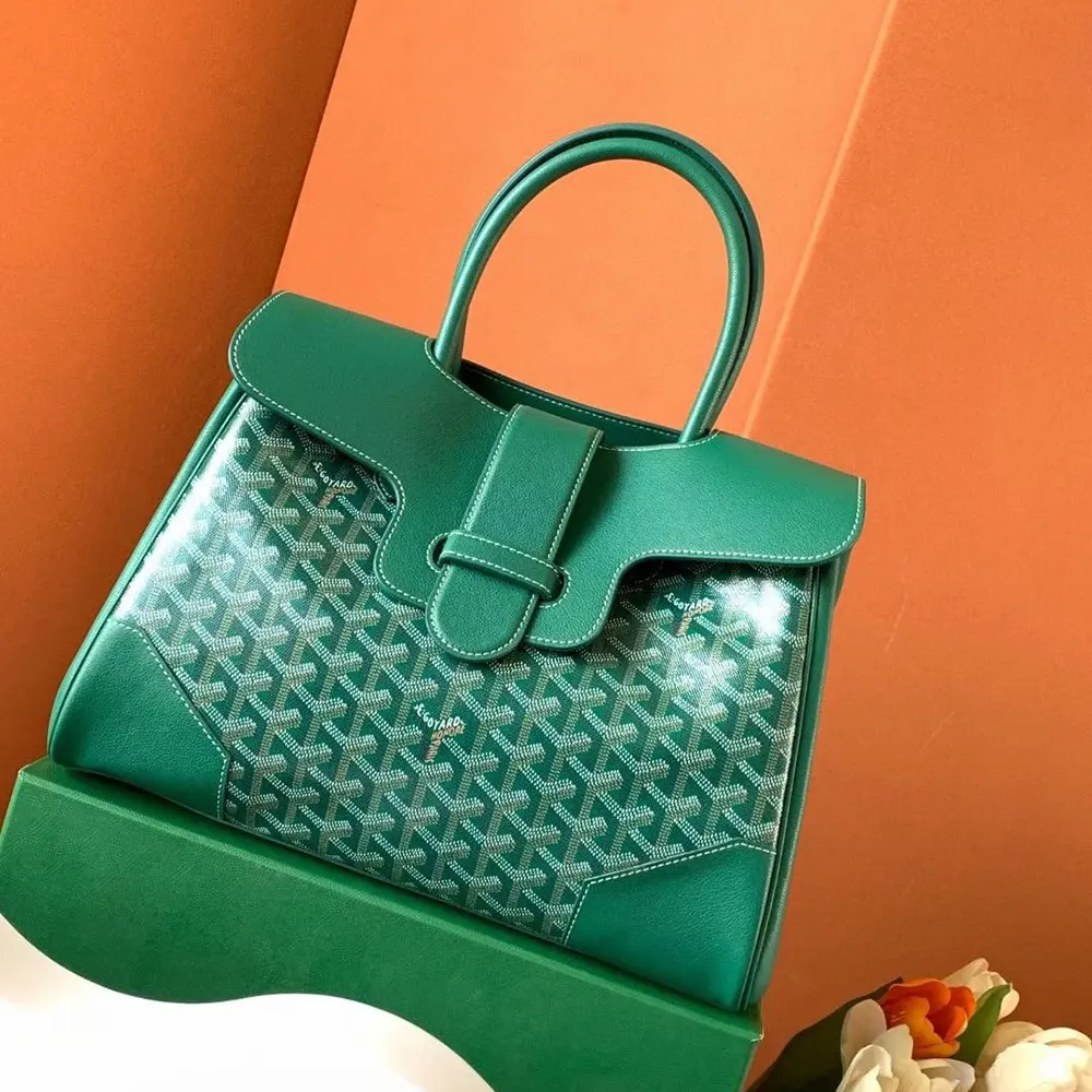 Close-up of gold-tone hardware and leather trim on Goyard Saïgon Tote Bag-Green