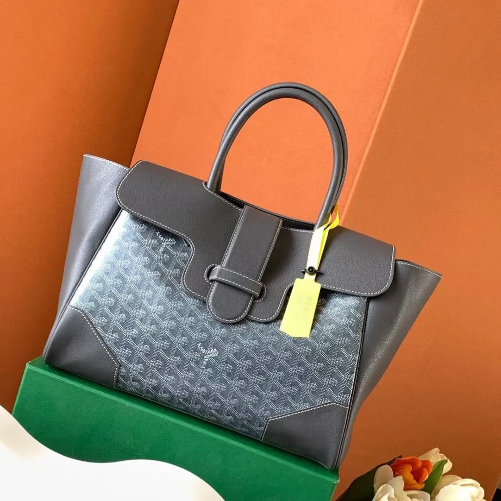 Side angle of Goyard Women Saïgon Tote Bag-Grey highlighting leather trim