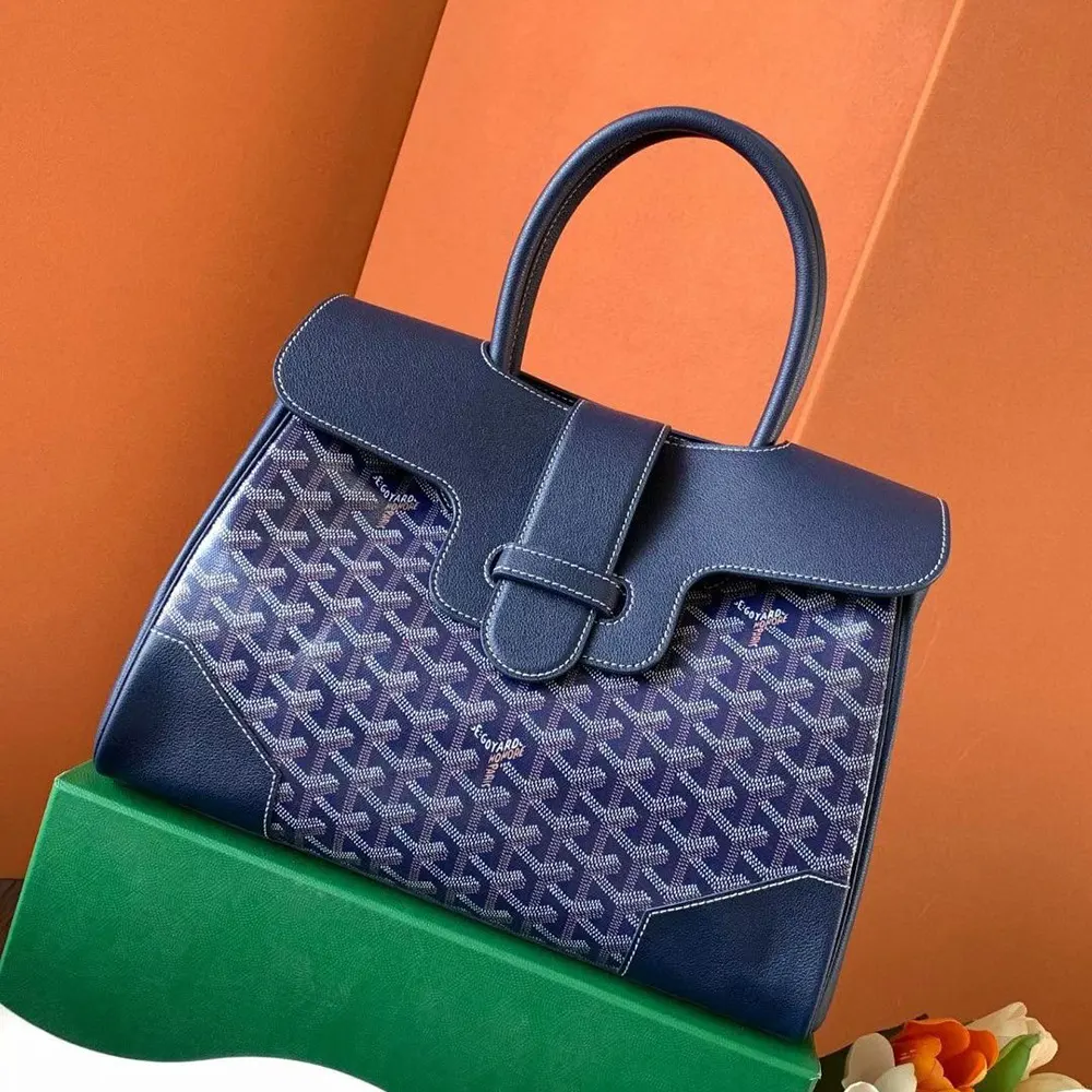 Side angle highlighting structured silhouette of Goyard Saïgon Tote Navy