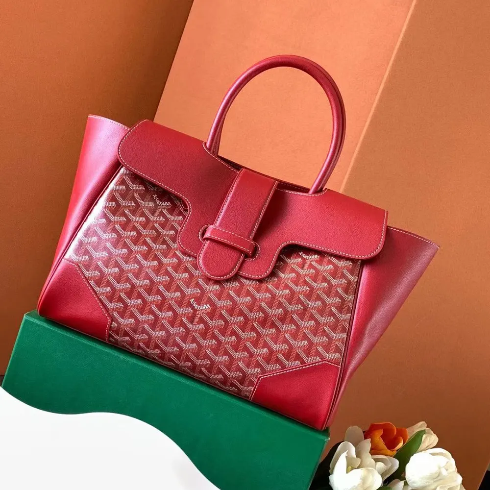Close-up of gold-tone hardware and red leather trim on Saïgon Tote Bag
