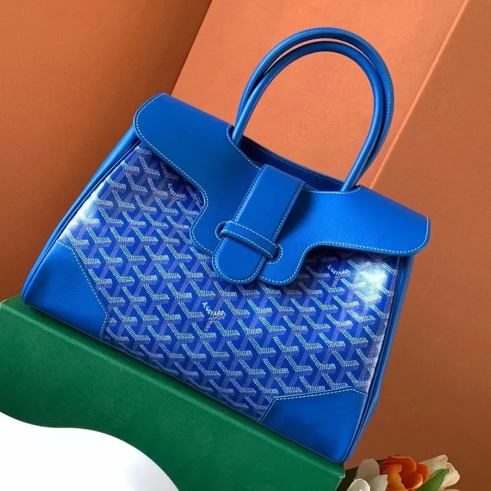 Close-up of leather handles and brass hardware on the Goyard Women Saïgon Tote Bag-Sky Blue
