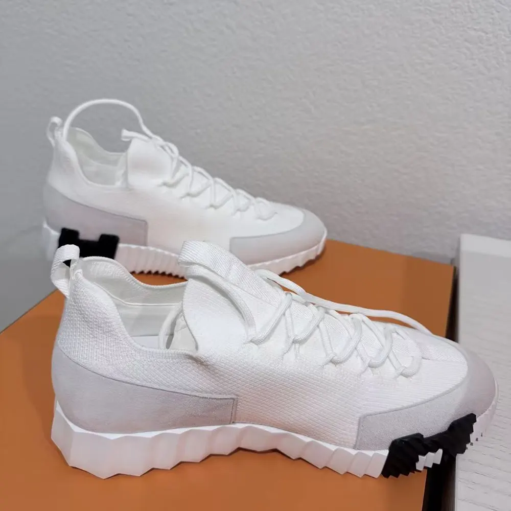 Close-up of white calfskin leather and embossed logo on Hermes sneaker