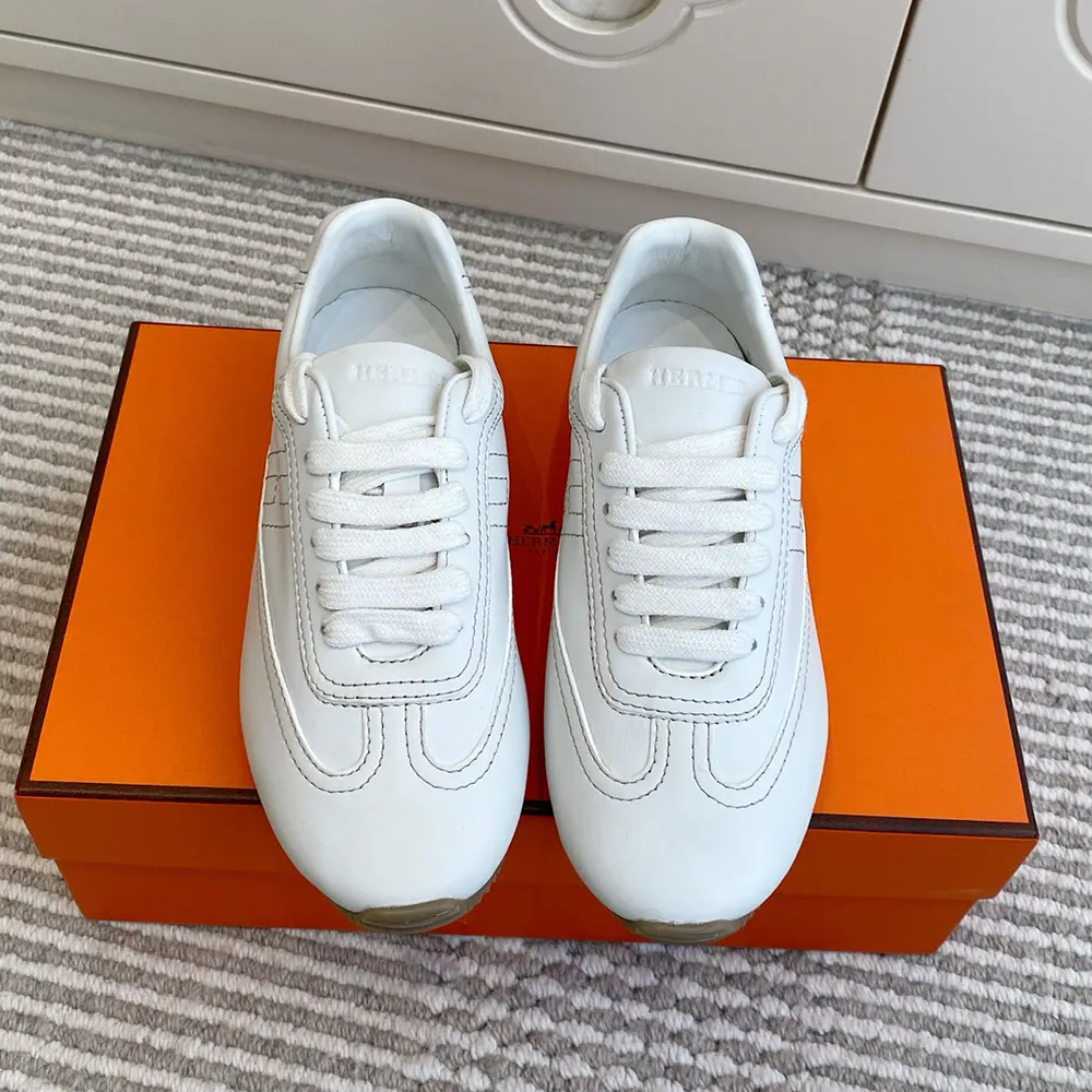 Close-up on white calfskin texture and Hermes signature detail