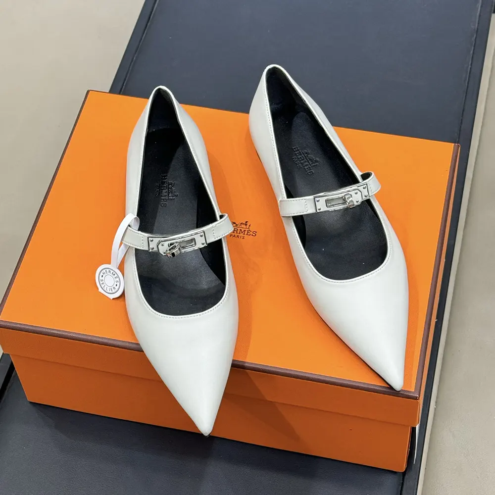 Close-up of signature Hermes hardware on white ballet flat