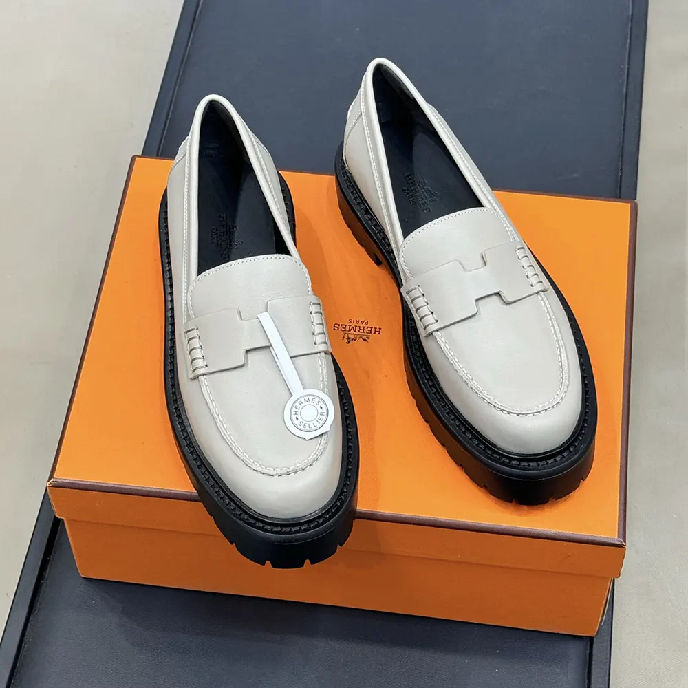 Close-up of soft gray calfskin leather and Hermes metal detail on loafer