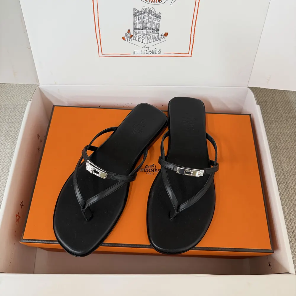 Close-up of signature Hermes 'H' cutout on Miss Sandal black leather