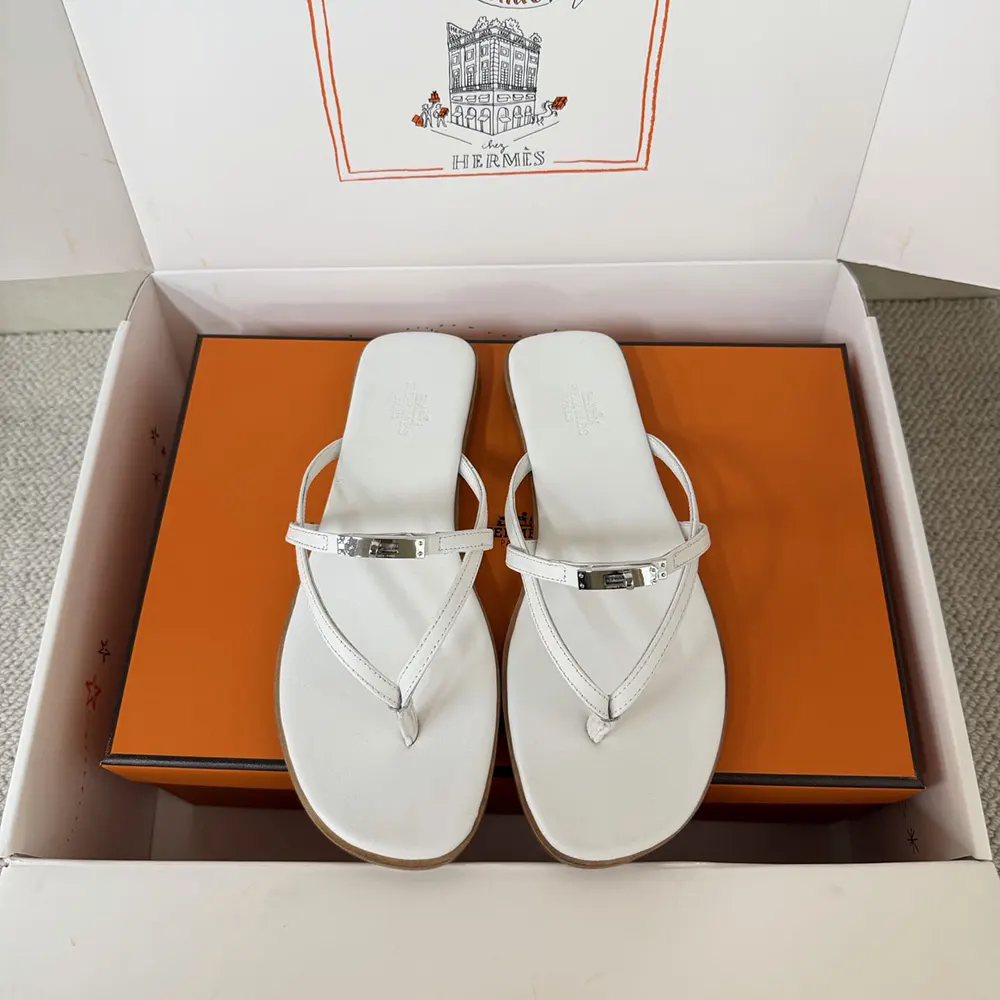 Close-up of Hermes signature H hardware on Miss Sandal in white calfskin