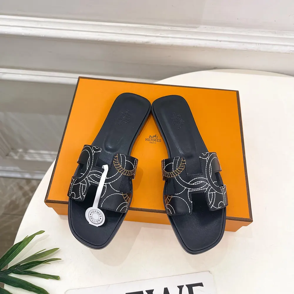 Close-up of signature ‘H’ cutout on Hermes Women Oran sandal black