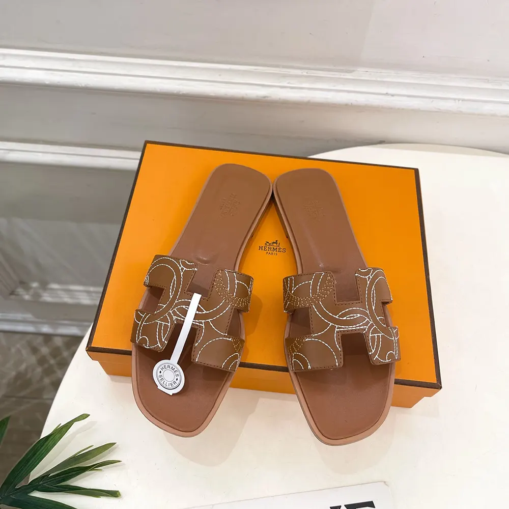 Close-up of equestrian embroidery on Hermes Women Oran sandal leather