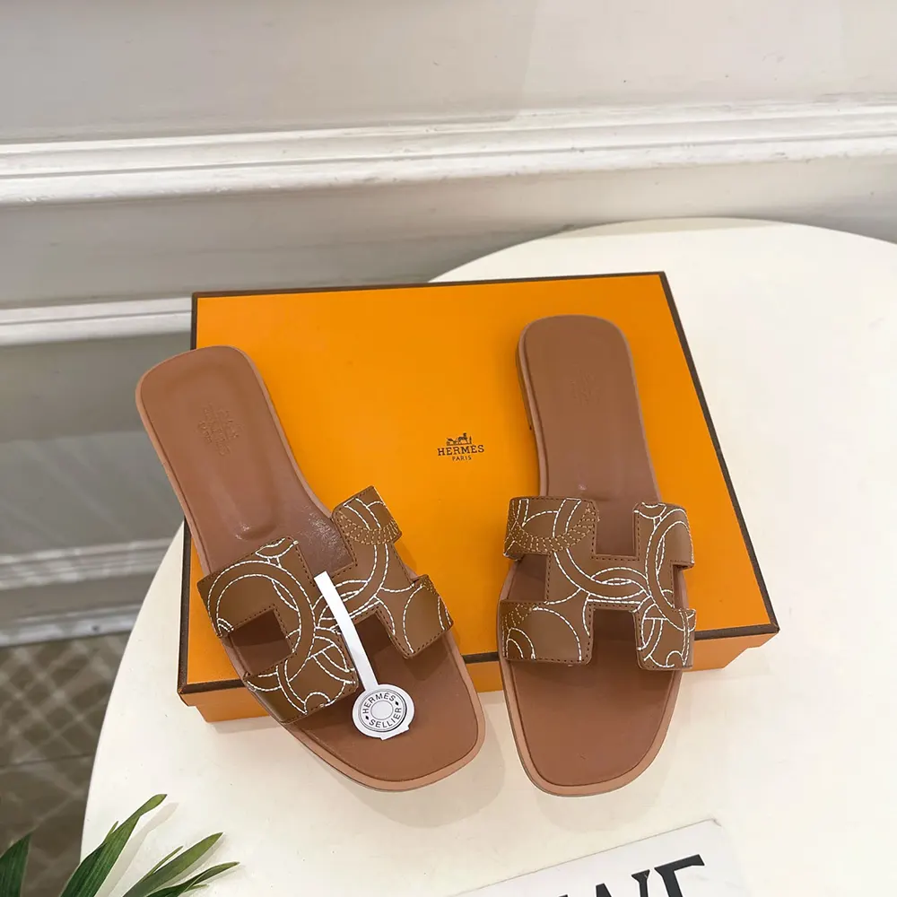 Top-down angle showing signature H cutout on Hermes Women Oran sandal