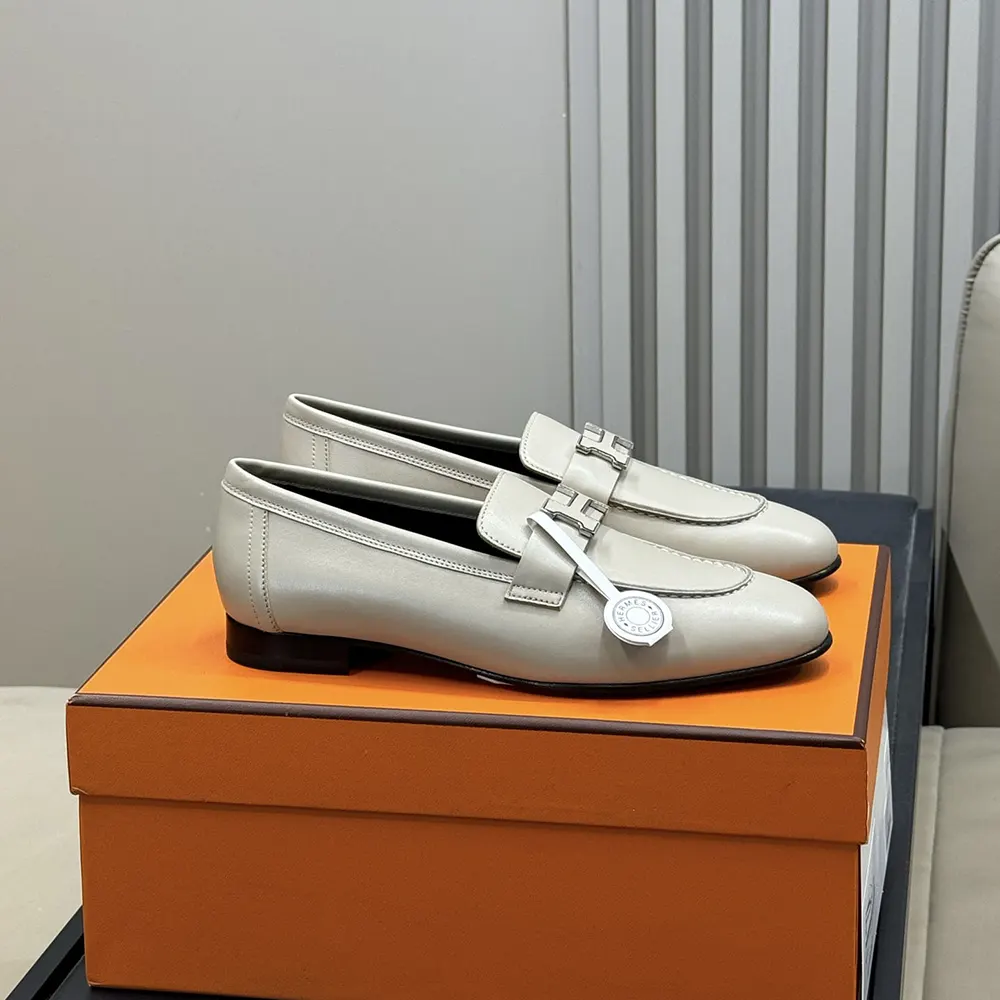 Close-up of goatskin texture and Hermes detail on gray loafer