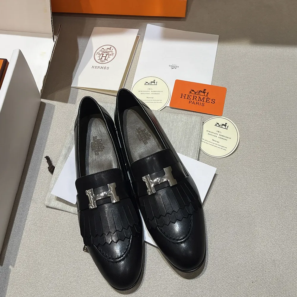 Close-up of Hermes Women Royal Loafer stitching and goatskin texture in black