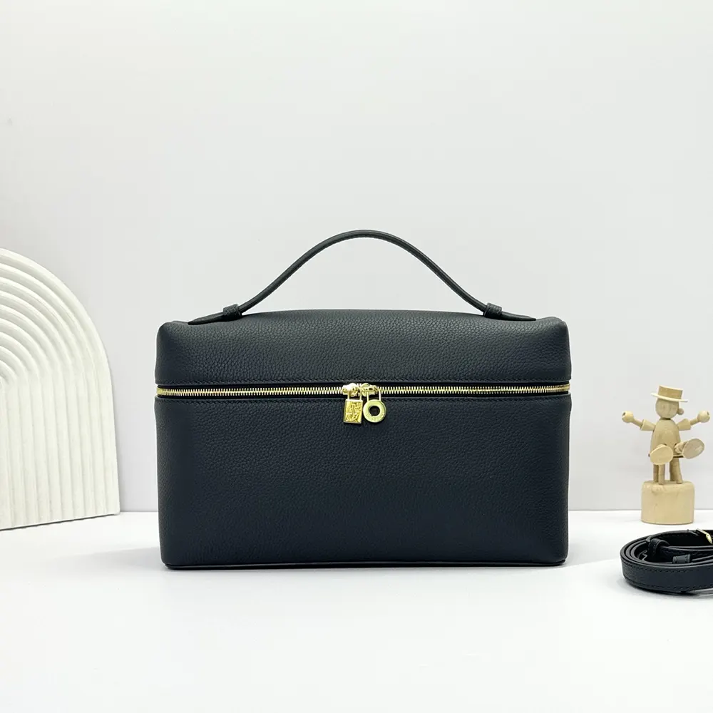 Close-up of navy calfskin leather and gold hardware on the bag