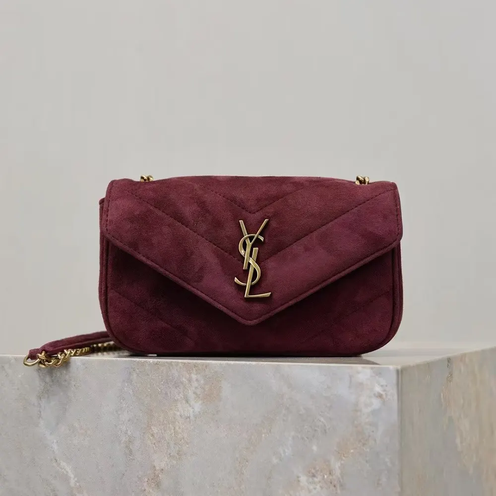 Close-up detail of gold YSL logo on Saint Laurent YSL Women Loulou Small suede bag