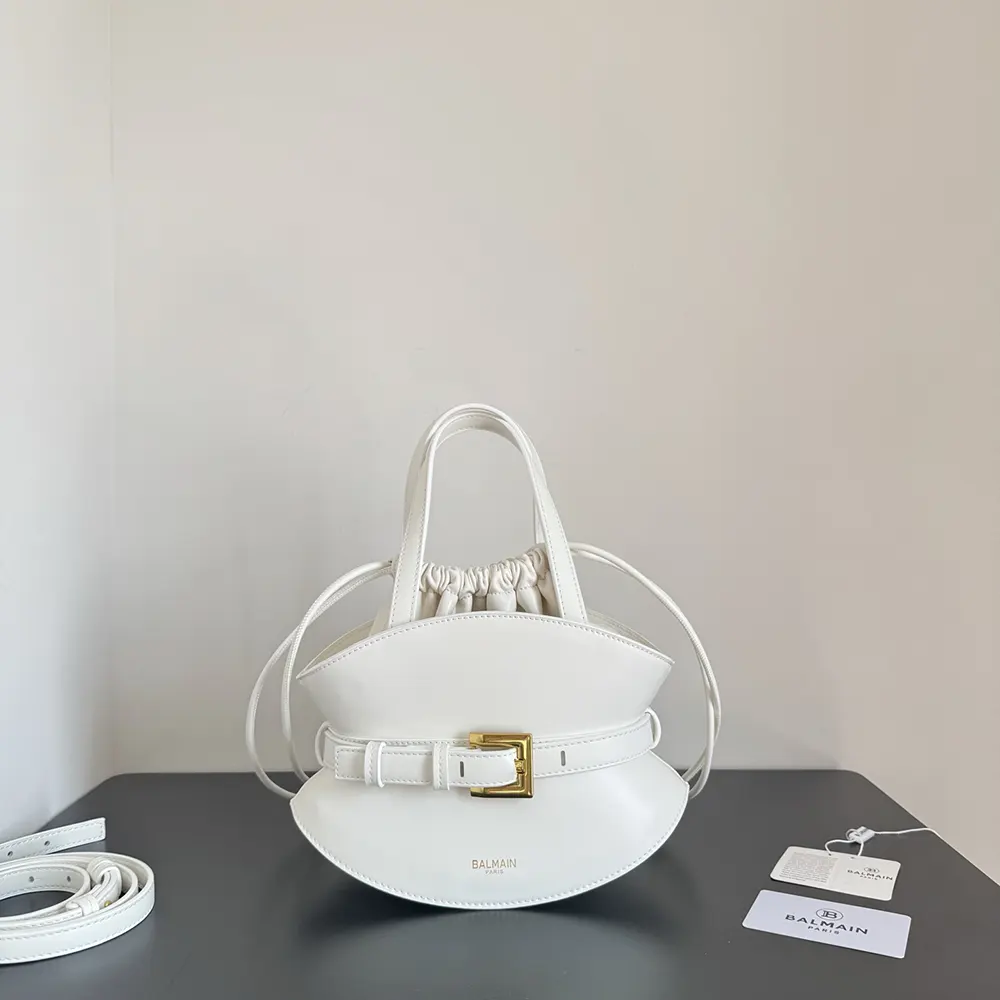 Close-up of Balmain gold-tone hardware on Shuffle Mini Bag white leather