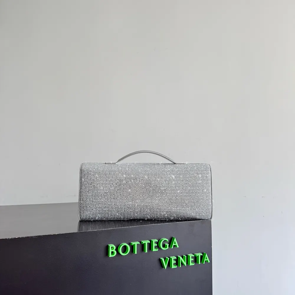 Side angle highlighting slim silhouette of Bottega Veneta Women Andiamo Clutch-Silver