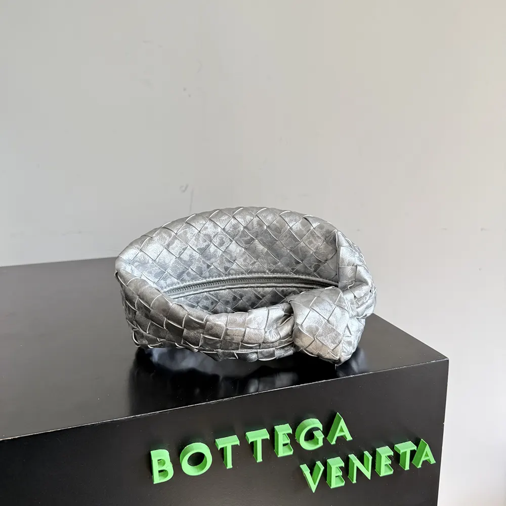 Side profile showing clasp and shape of Mini Jodie-Silver bag