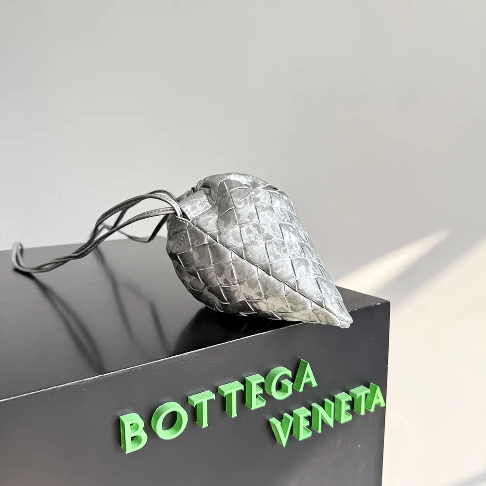 Side angle showing slim profile of Bottega Veneta Women Small Dustbag-Silver