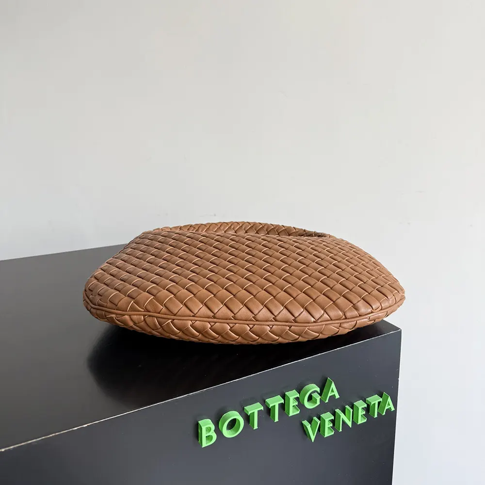 Side profile showing gold hardware of Bottega Veneta Women Small Veneta-Brown