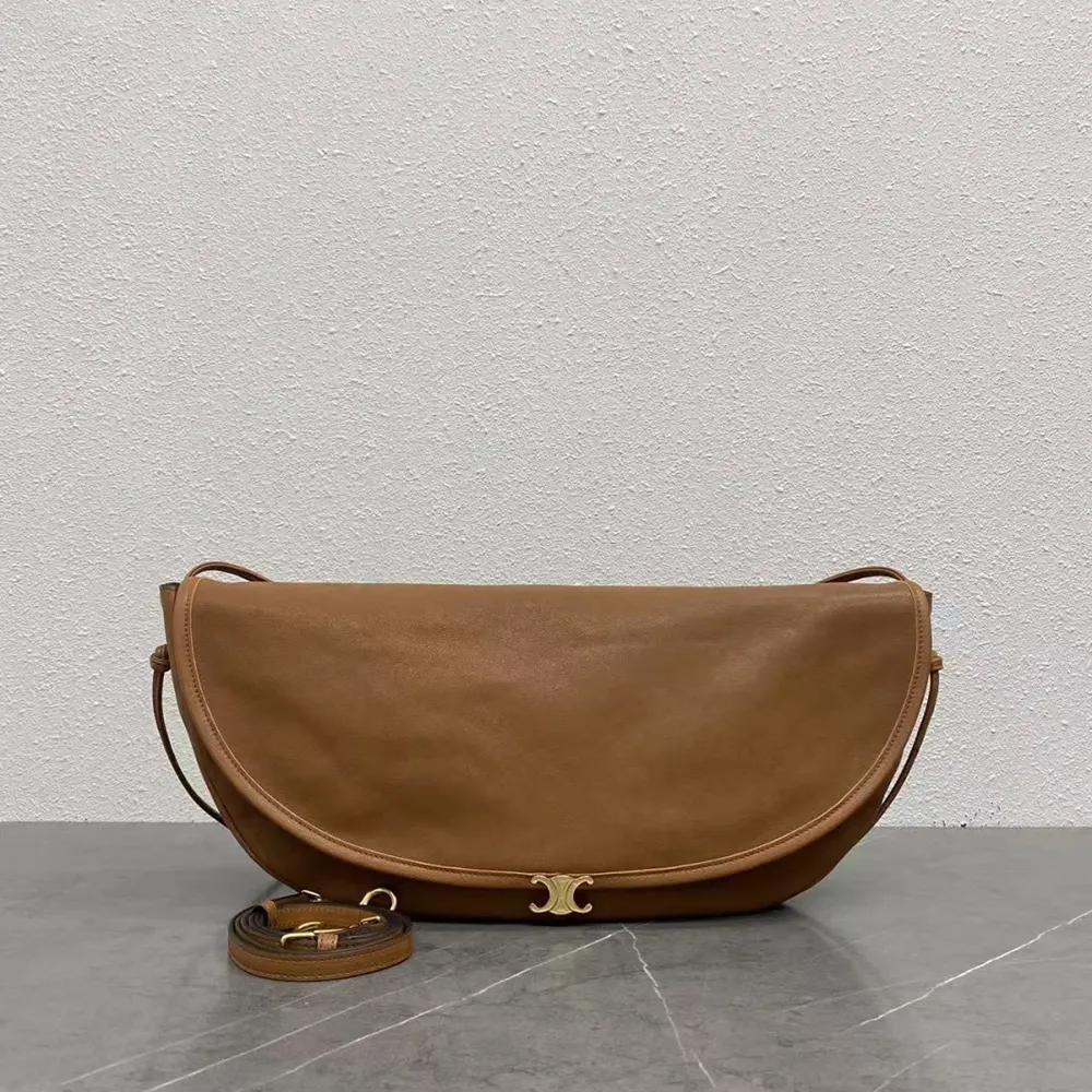 Close-up of gold-tone Triomphe clasp on Celine brown shoulder bag