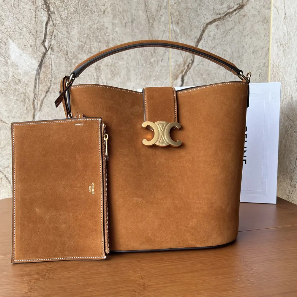 Close-up of gold-tone chain strap and suede leather details