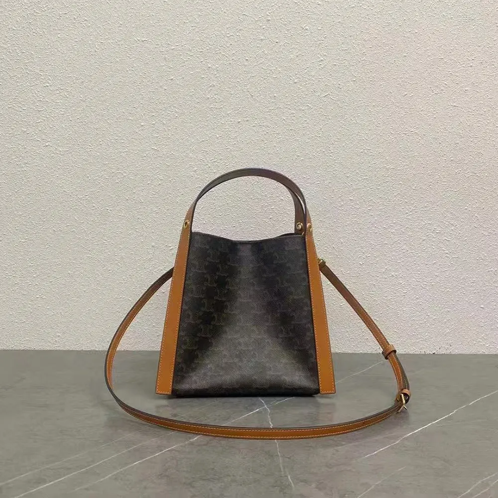 Side angle showing structured silhouette of Celine Women Small Cube Bag in brown
