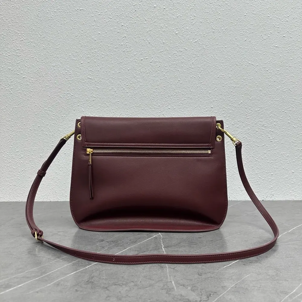 Side profile showing adjustable strap on Celine Soft Triomphe Besace maroon bag