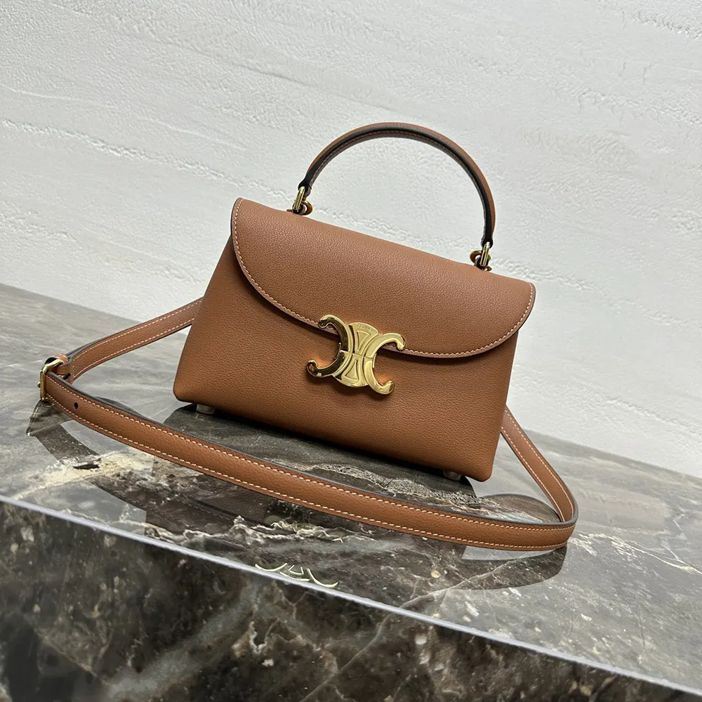 Close-up of brown satinated calfskin leather and gold hardware on Celine bag