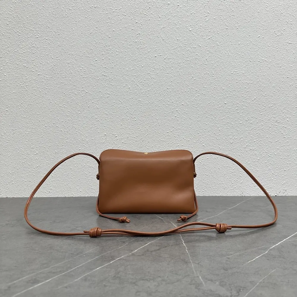 Side profile showing structured silhouette of Celine Women Trio Flap brown shoulder bag