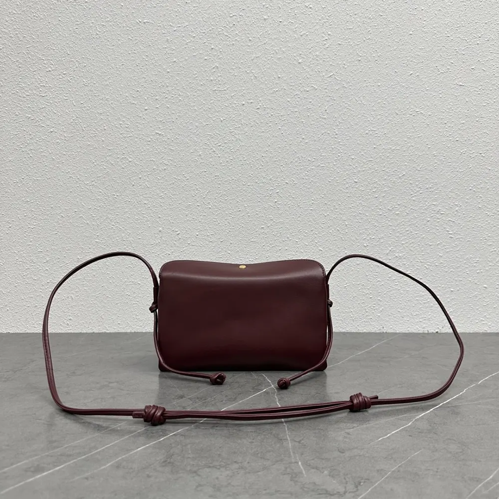 Side angle showing compact silhouette of Celine Women Trio Flap In Smooth Lambskin-Maroon