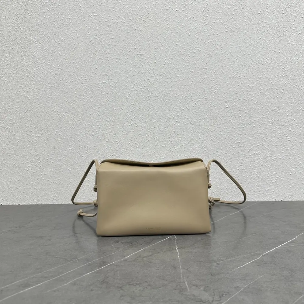 Close-up of gold-tone hardware on Celine Women Trio Flap In Smooth Lambskin-Sandy