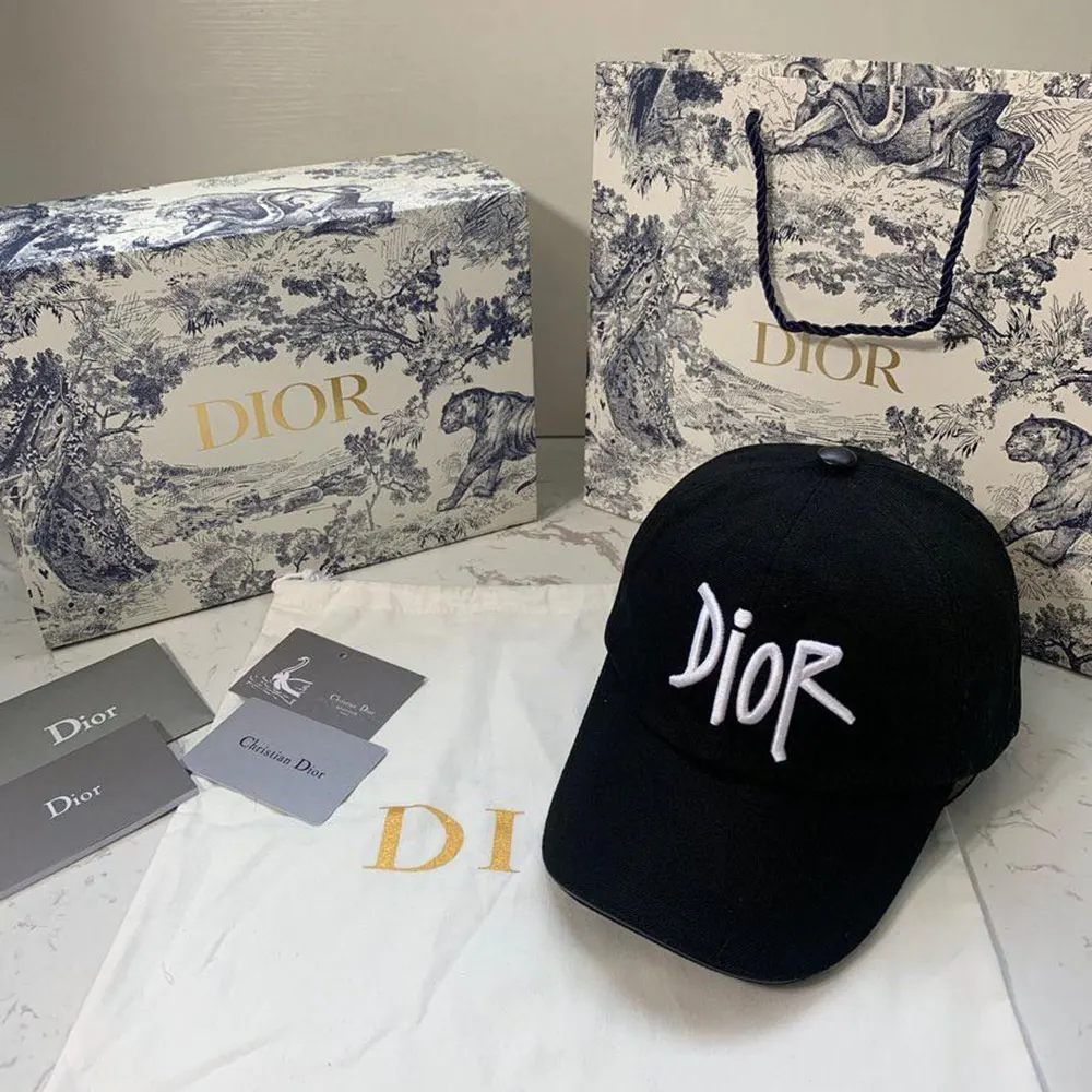 Close-up on embroidered Dior Stussy logo on black cotton canvas hat