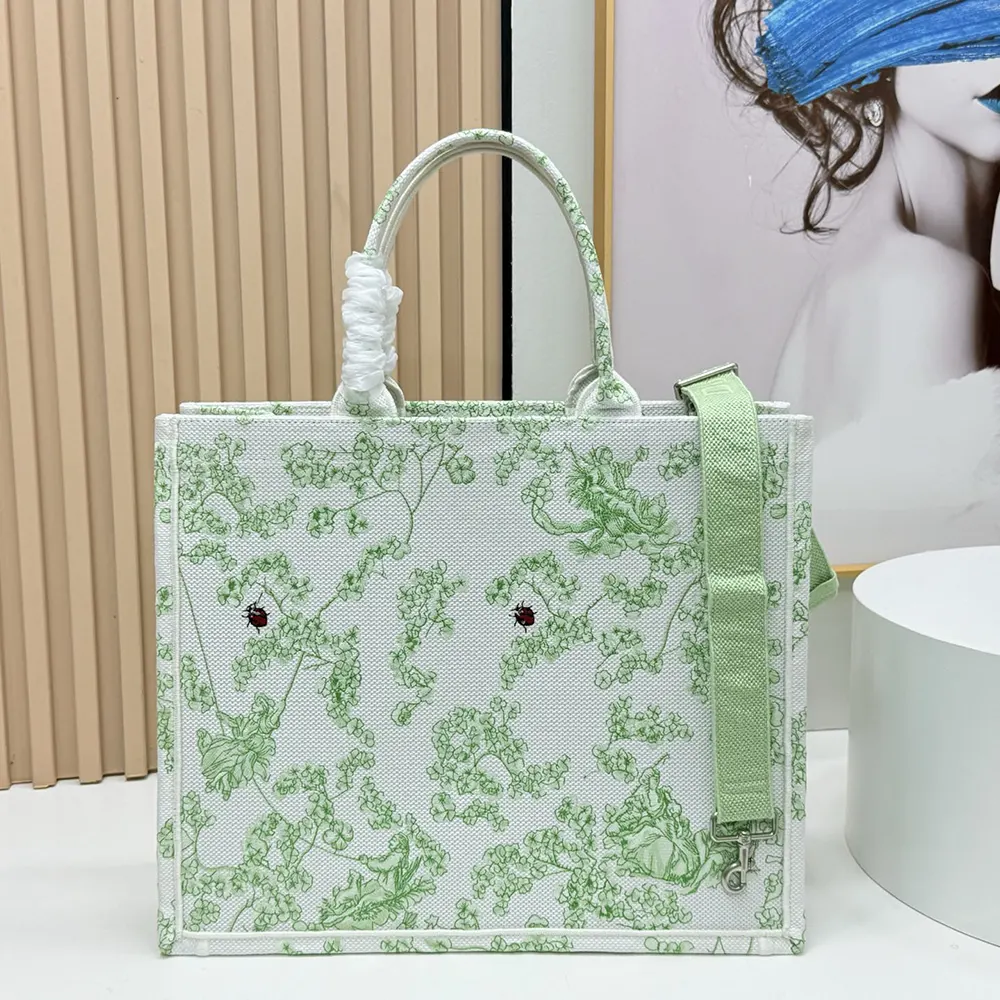 Side view showing strap and silver hardware on Dior Medium Tote