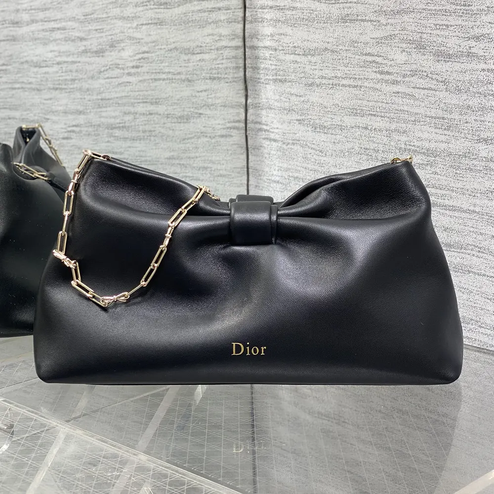 Close-up of silver-tone hardware and black lambskin texture on Dior Bow Bag