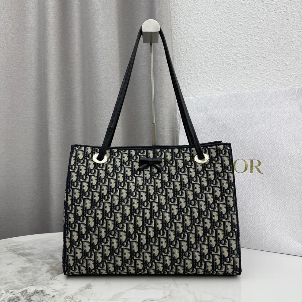 Close-up of blue Dior Oblique jacquard fabric on Dior women’s bag