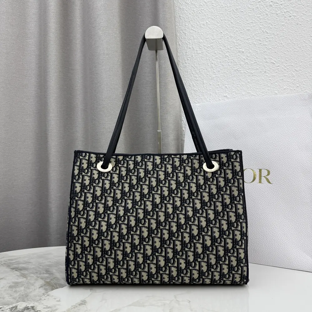 Side angle showing silver hardware on Dior Women Medium Shopping Bag