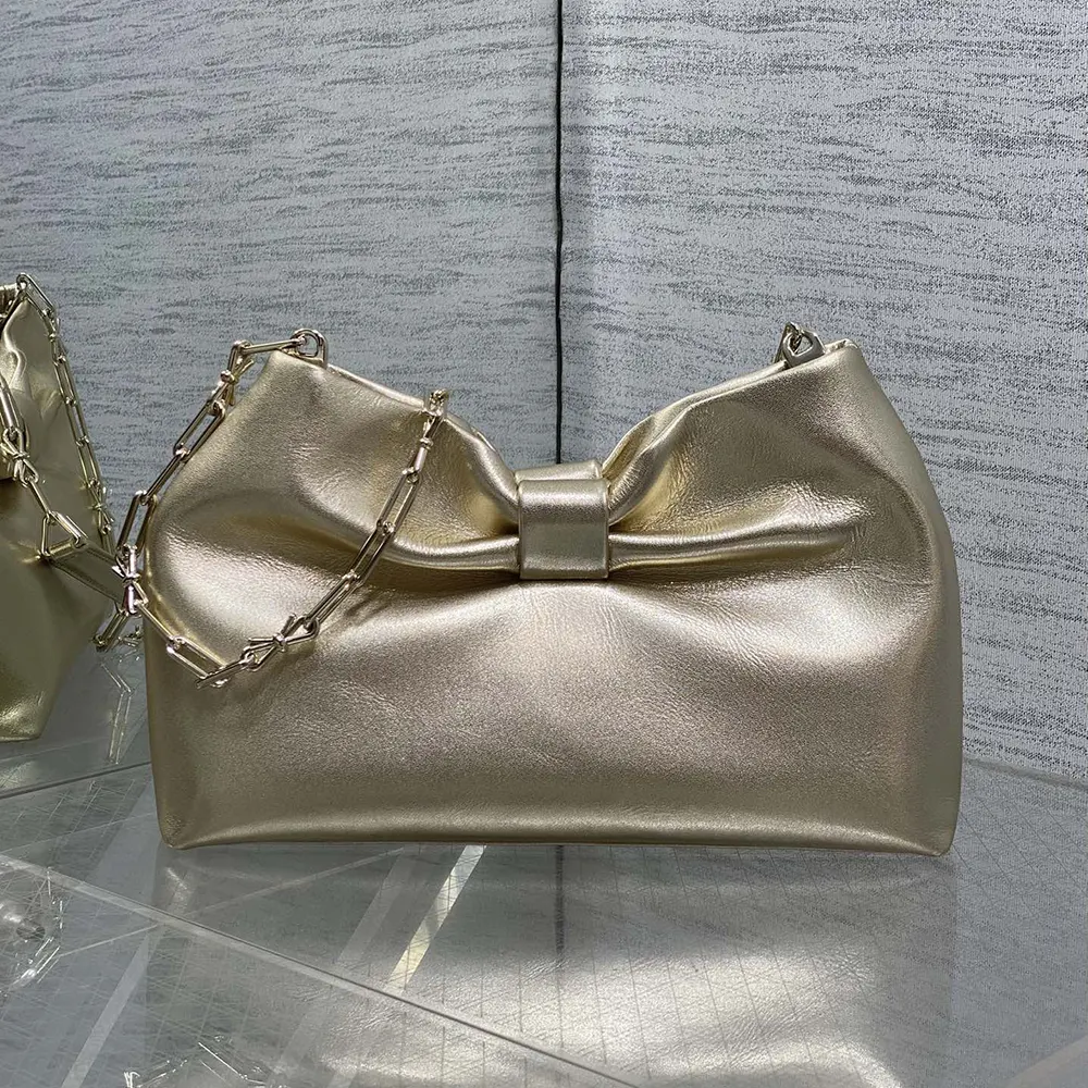 Side profile showing magnetic closure on Dior Women Or Small Dior Bow Bag Mekong