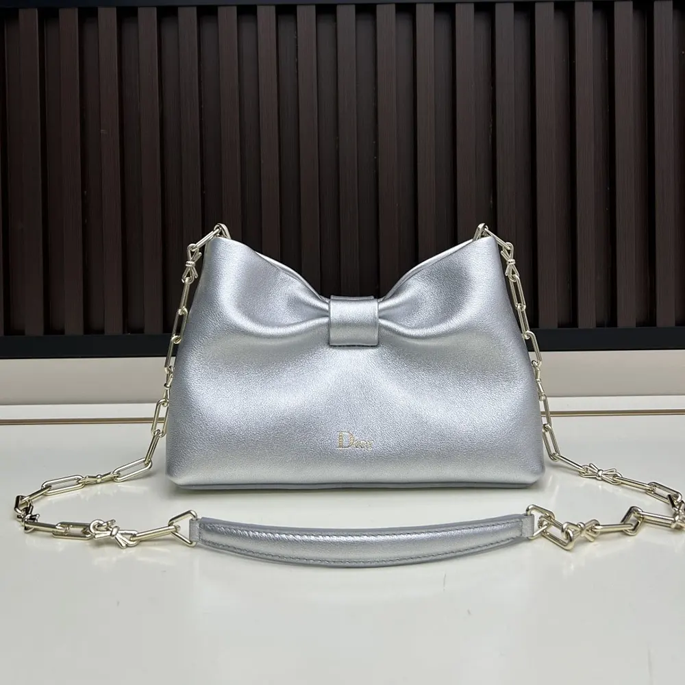 Close-up of silver-tone bow hardware on Dior Women Or Small Dior Bow Bag