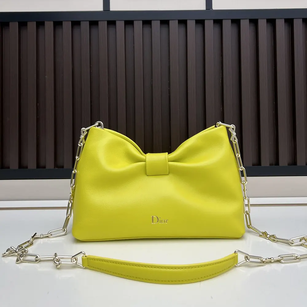 Close-up of signature bow hardware on Small Dior Bow Bag Buttercup