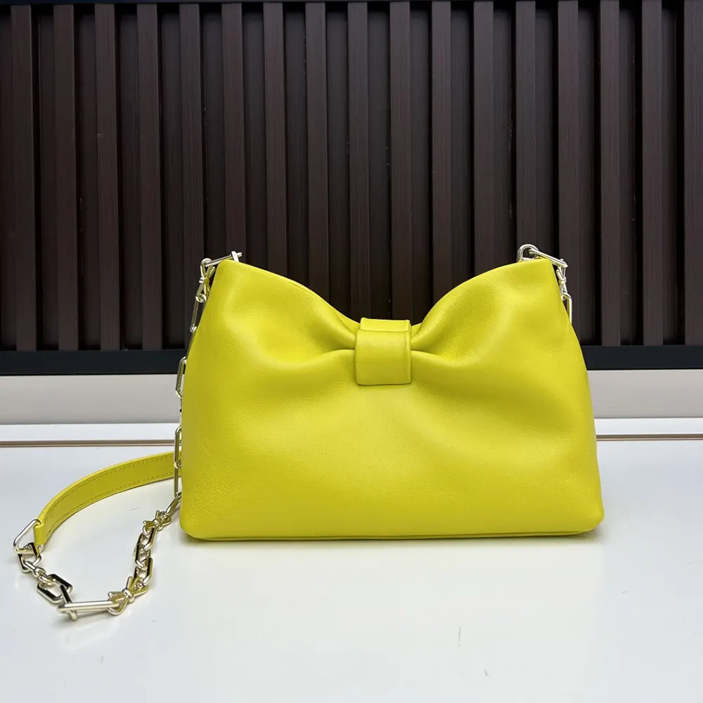 Side angle showing lambskin texture on Dior Women Small Dior Bow Bag