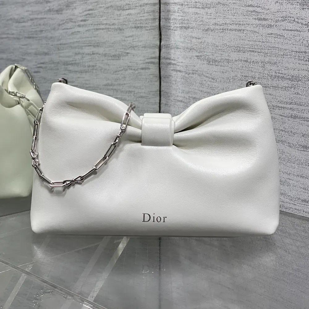 Side angle highlighting compact silhouette of Dior Women Small Dior Bow Bag Latte Lambskin