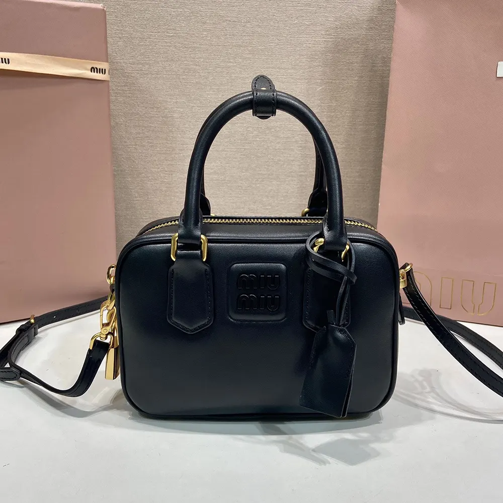 Close-up of silver-tone hardware and flap closure on Miu Miu Women Arcadie Leather Bag-Black