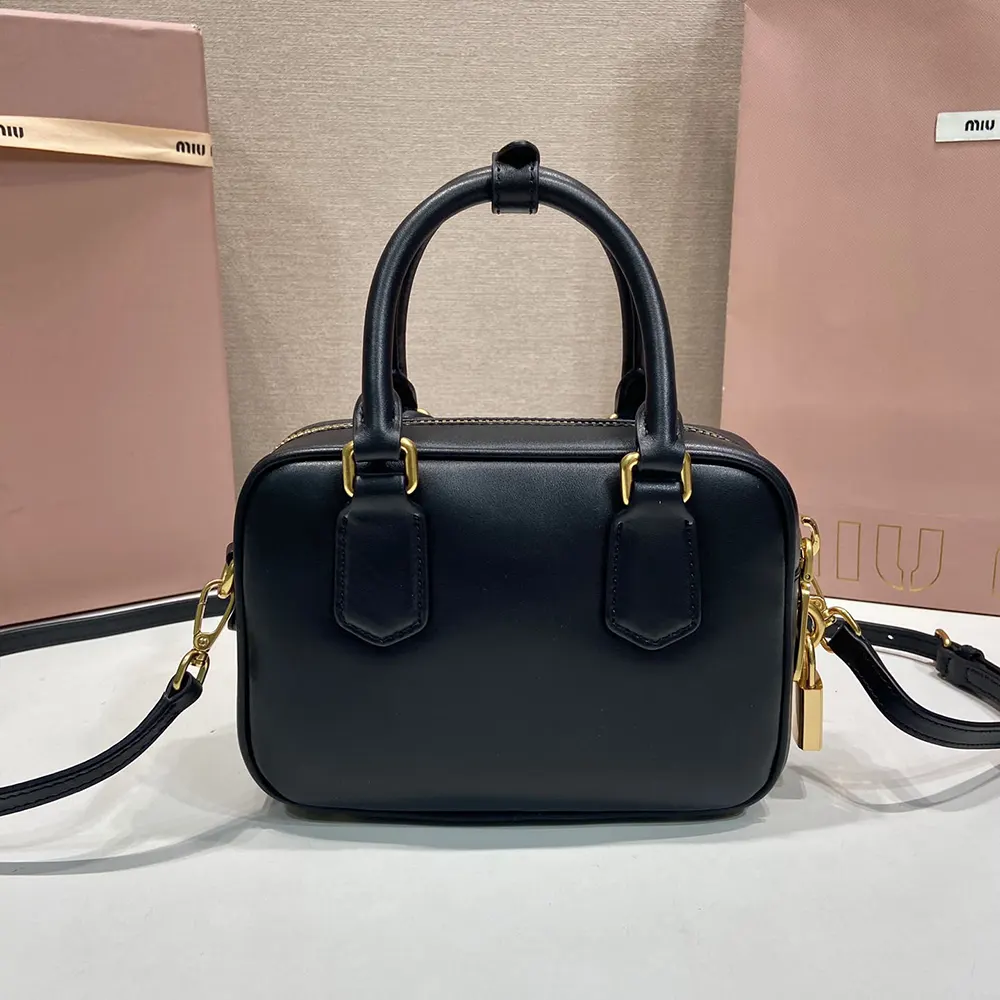 Side angle of Miu Miu Women Arcadie Leather Bag-Black with adjustable strap visible