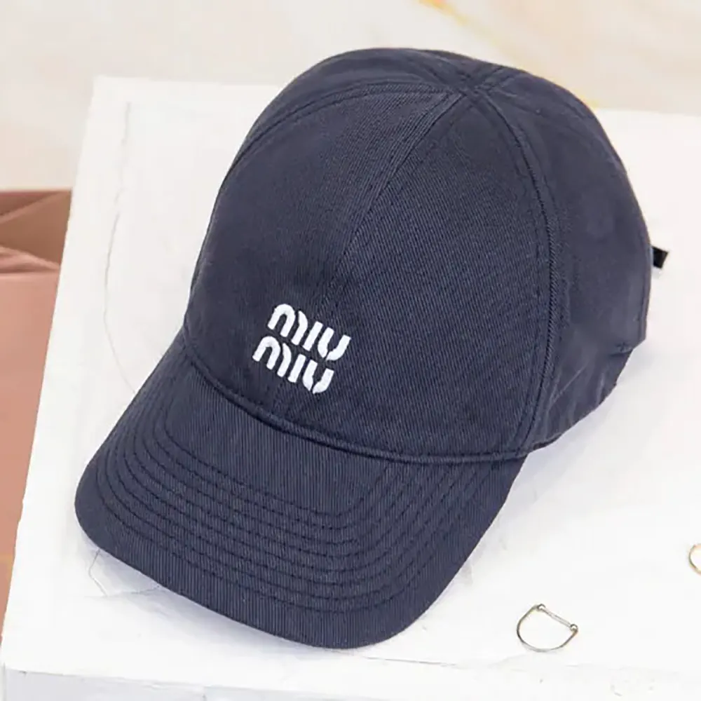 Close-up of embroidered logo on Miu Miu Women Denim Baseball Cap-Blue/Red