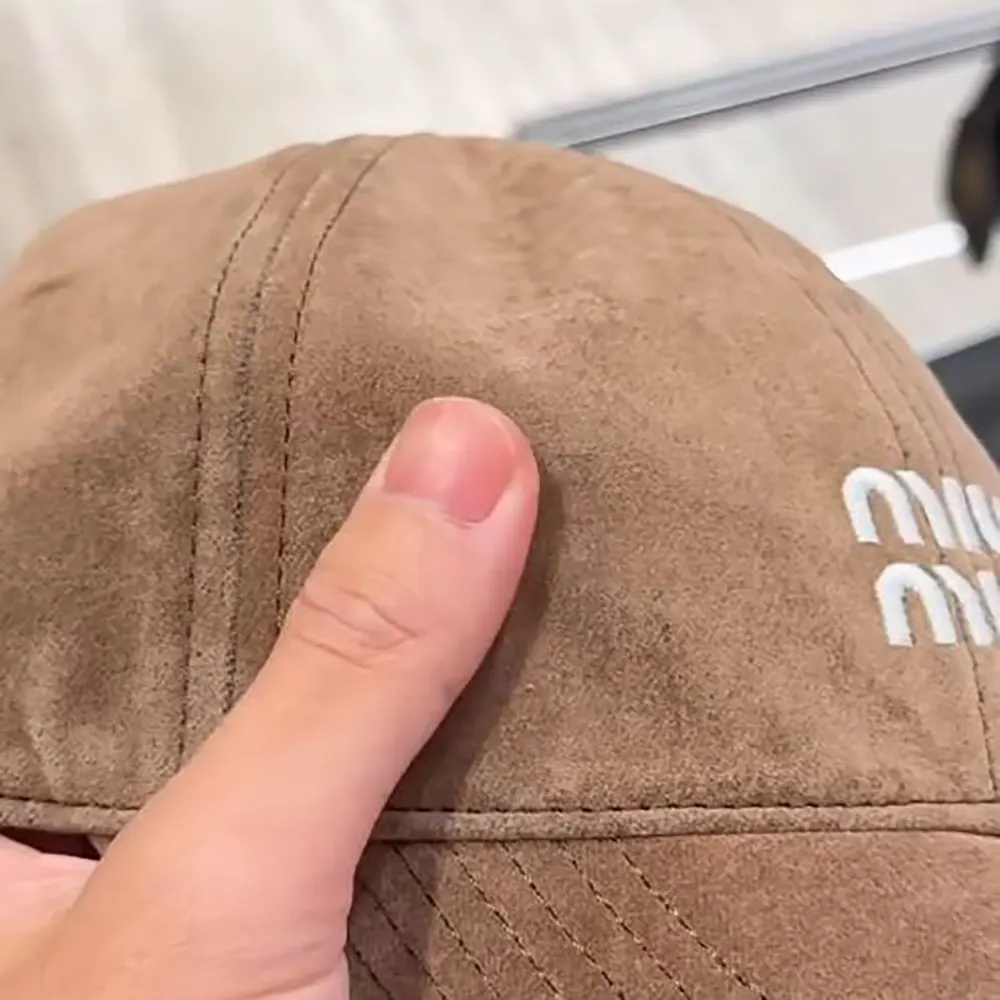 Side angle showing adjustable strap of Miu Miu Velvet Baseball Cap